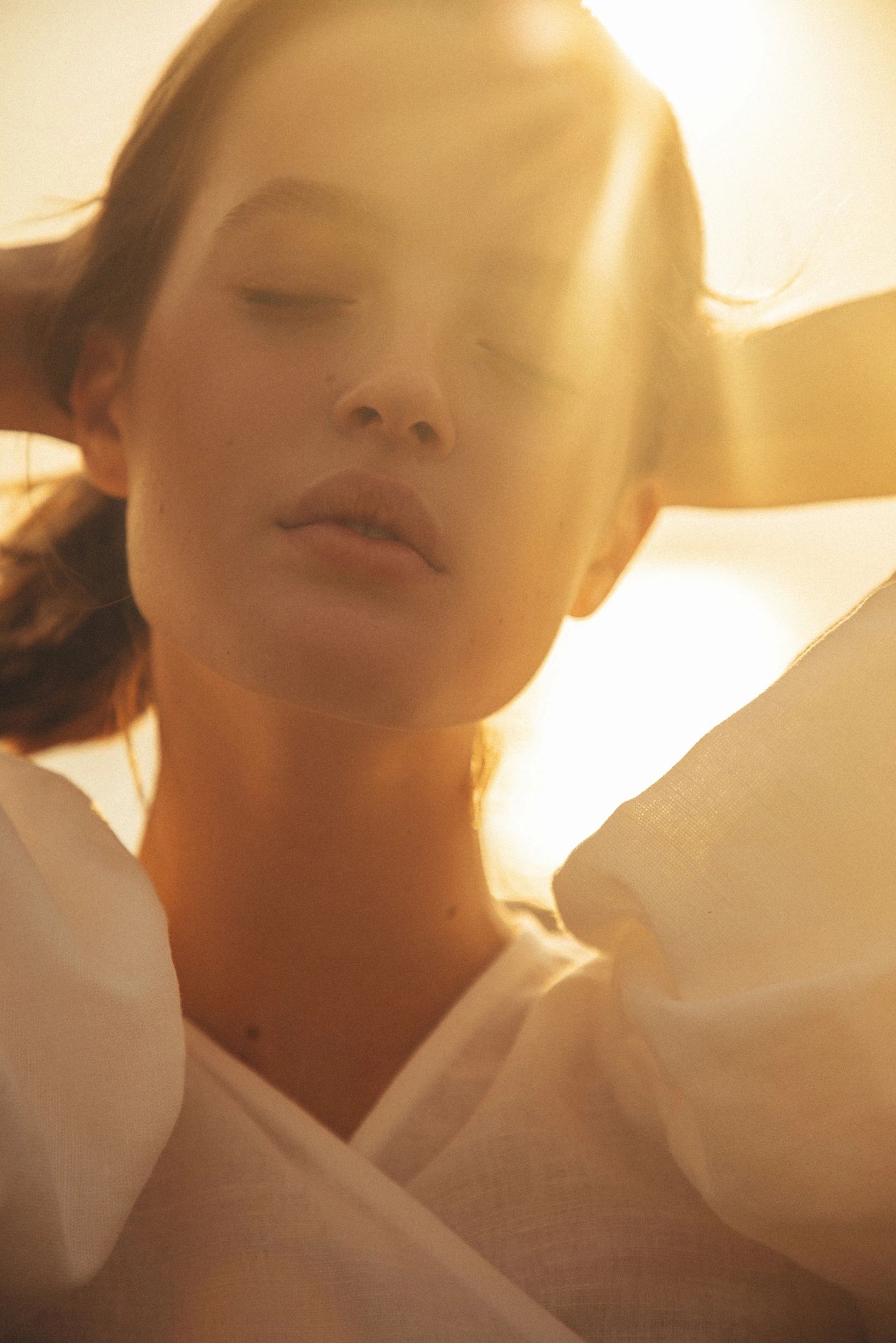 Sunlit coastal portrait with warm, relaxed energy